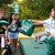 Student handing out green blankets