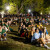 Students sitting on lawn watching drone show