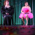 two drag queens sitting on stage 