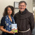 Br. Jacek Orzechowski, O.F.M., presents encyclical to Assemblywoman Michaelle Solages