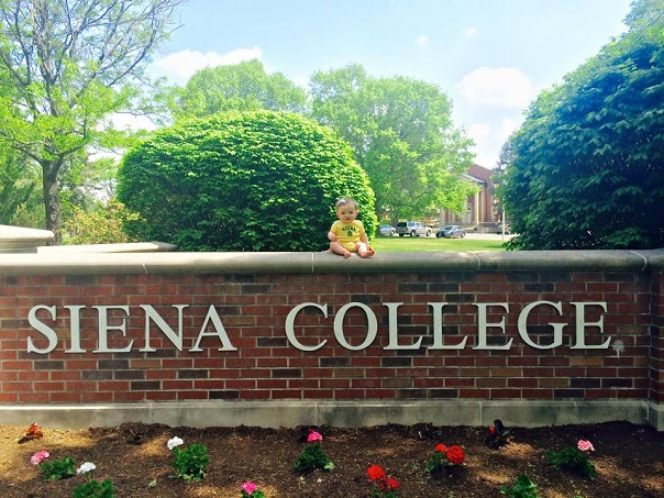 Siena Clemenza poses on the Siena sign