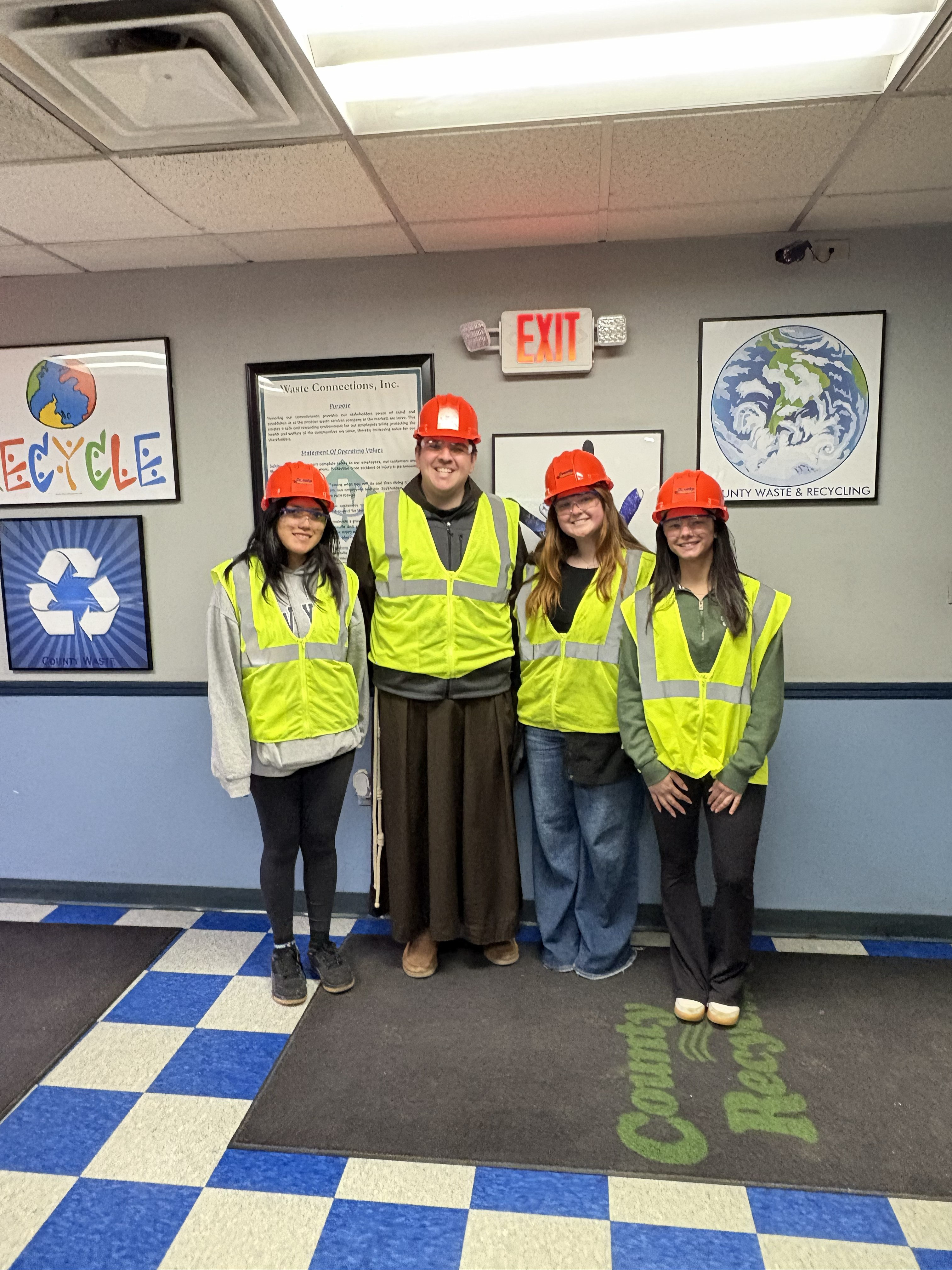 Group photo of students and friar on county waste visit
