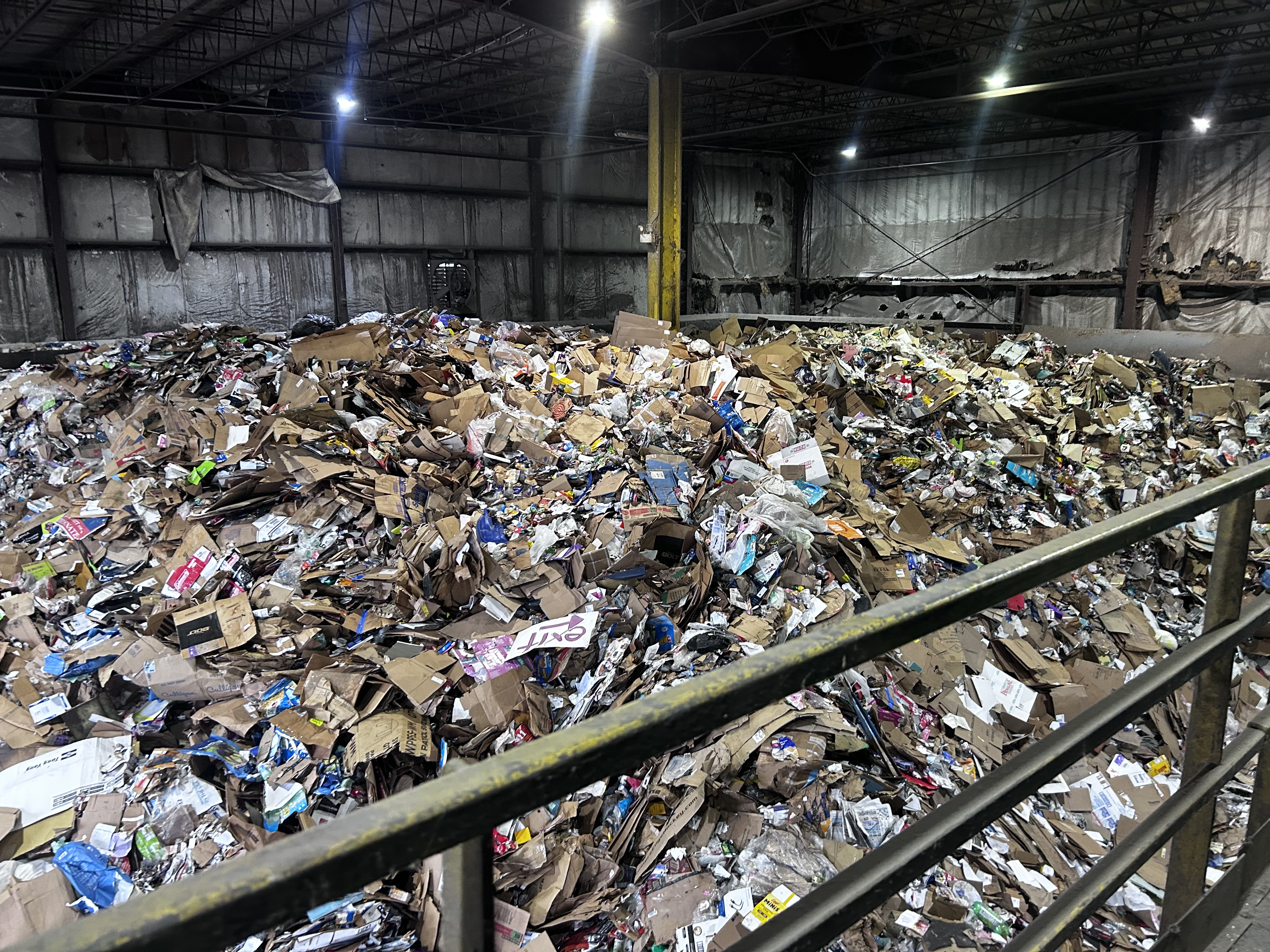 Image of large pile of recycling material and contaminants prior to the first step of processing