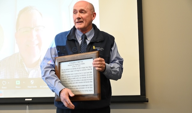 Mark Frost holding plaque at the announcement of the room name dedication
