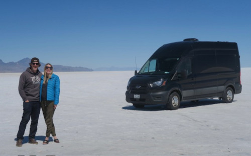 Alyson and her husband standing by their adventure van