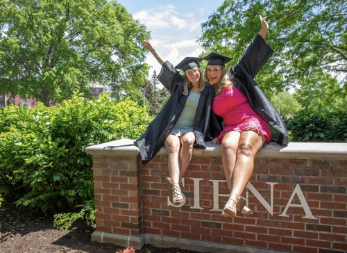 Emily at graduation with a friend