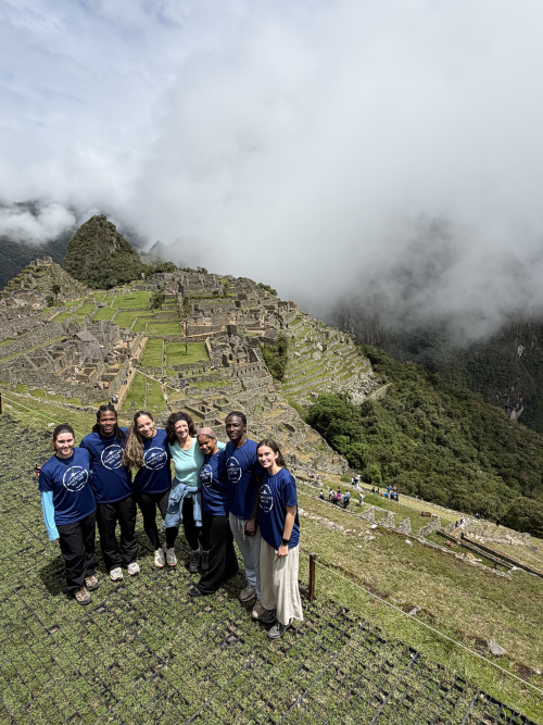 Group standing in front of Machu Pichu in Peru