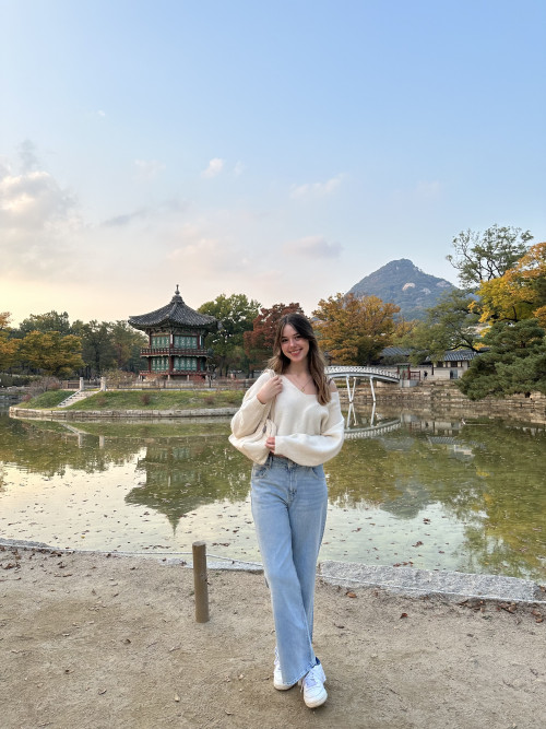 Girl standing in front of traditional Korean temple