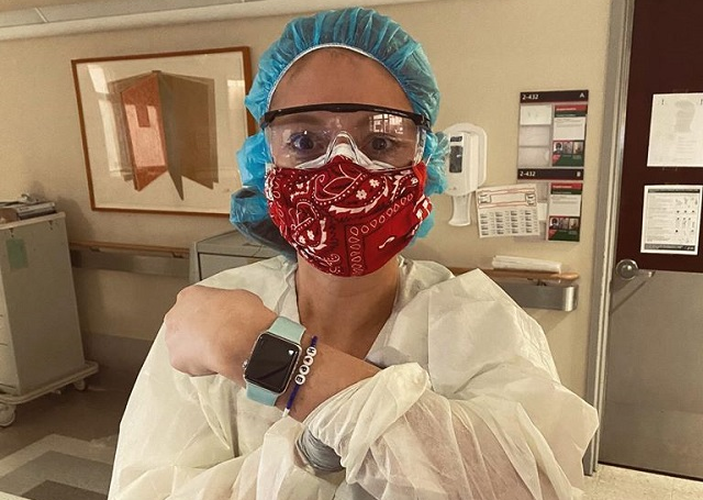 Sam dressed in medical coverings with a mask on