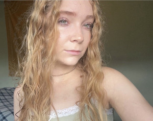 A selfie of a young woman with long blonde hair