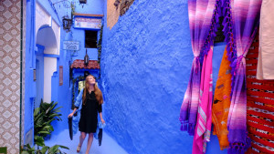 Girl looking at blue buildings in Morocco